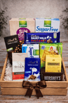 Coffee, tea, chocolates and cookies arranged in a wooden gift crate