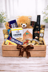 Teddy bear and assorted chocolate gift crate in a wooden box with ribbon